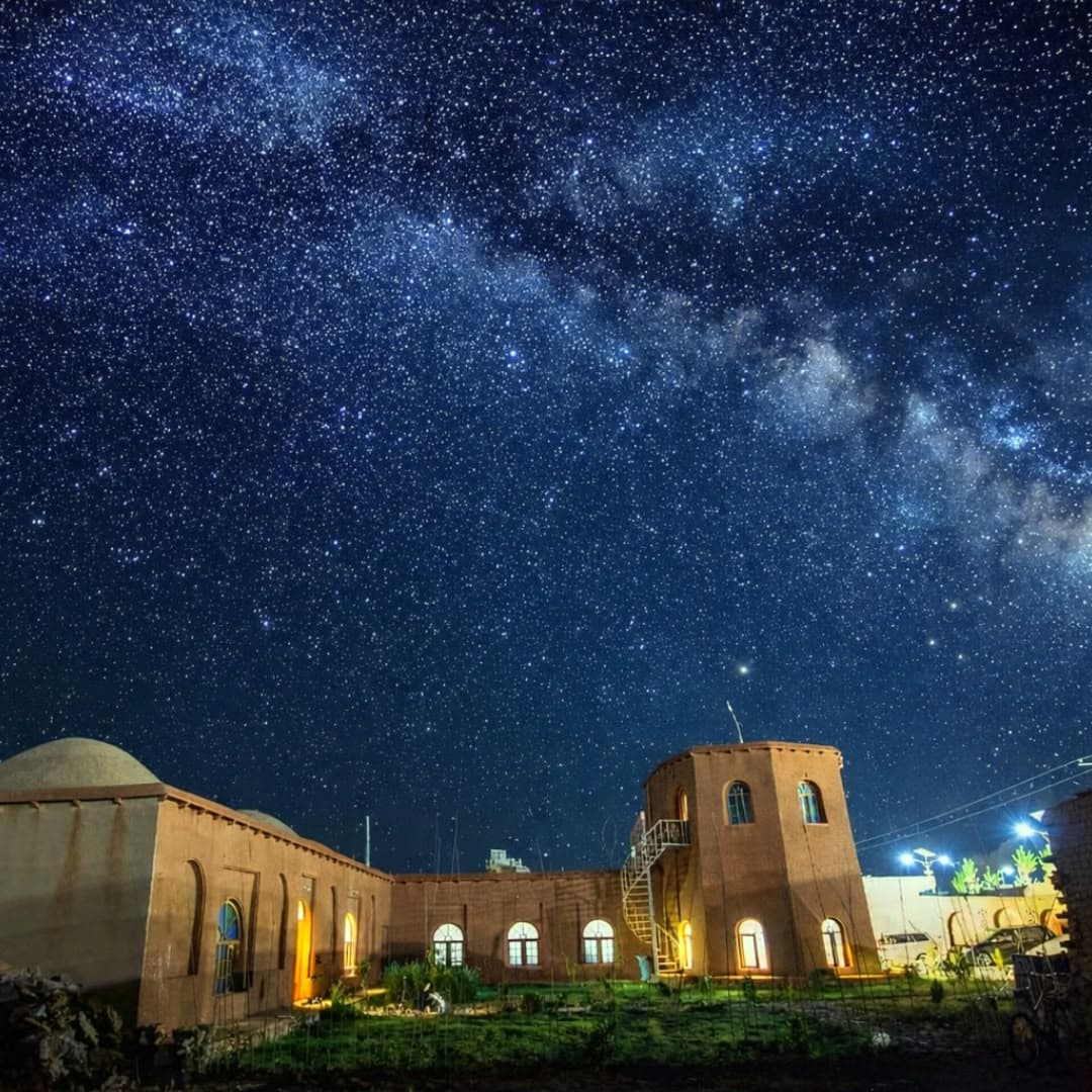 An aerial view of the hotel beneath the Milky Way